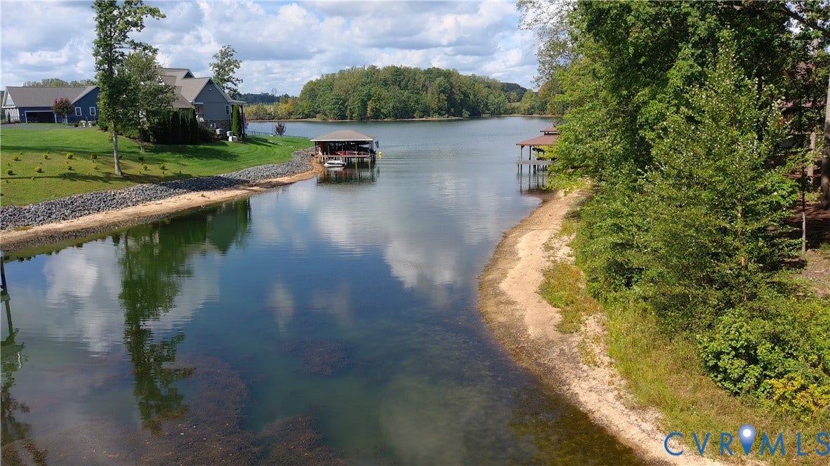 0 Wolftrap Court, Lighthouse, Bumpass, VA 23024 Waterfront property featuring a private boat dock, natural shoreline, and manicured landscaping