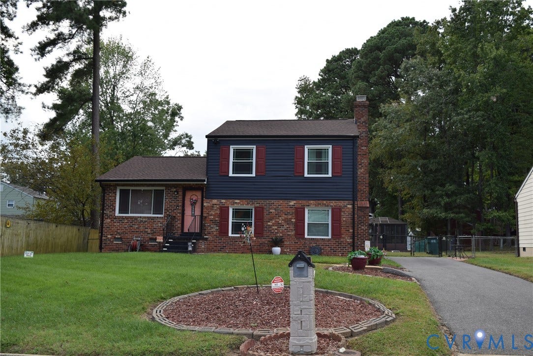3102 Oxnard Road, Henrico, VA 23223 Brick and siding exterior with red shutters, a paved driveway, and mature landscaping
