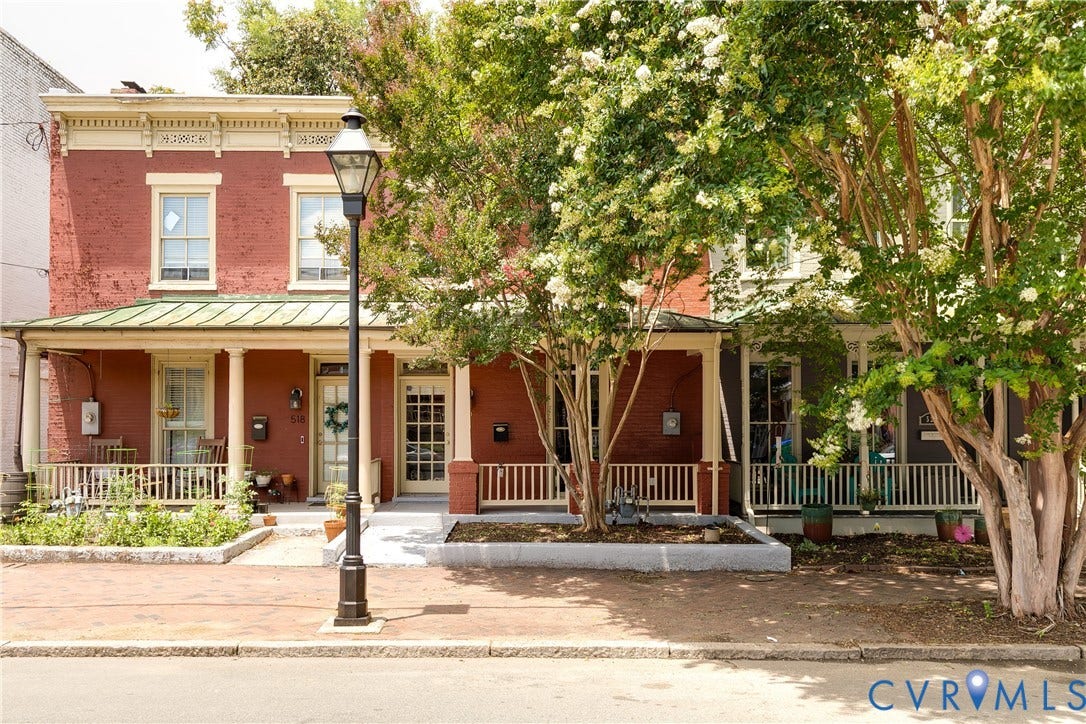520 N 1st Street, Richmond, VA 23219 Brick exterior with light-colored trim and an awning-covered porch