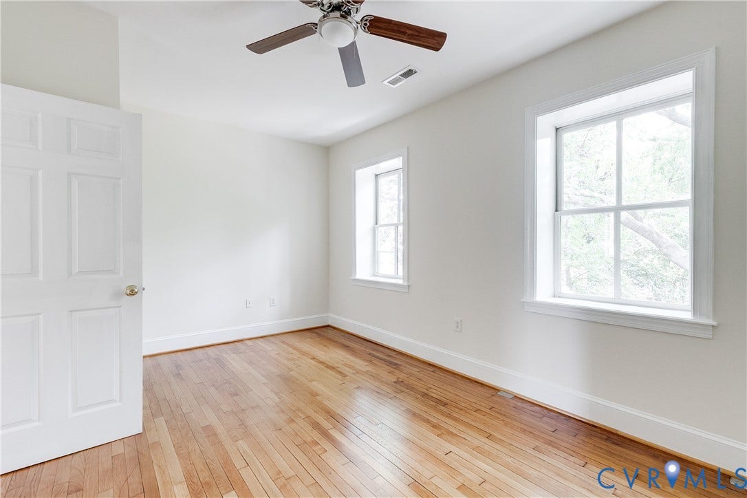 520 N 1st Street, Richmond, VA 23219 Hardwood flooring, painted white walls, recessed window frames, ceiling fan light fixture, white six-panel door