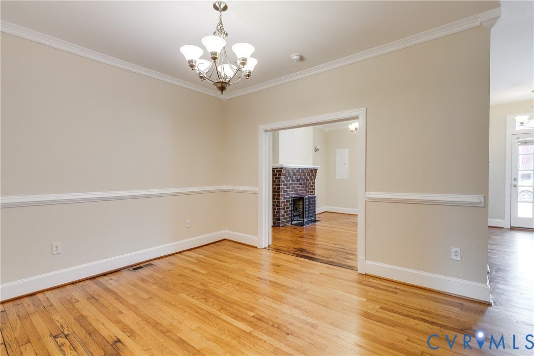 520 N 1st Street, Richmond, VA 23219 Hardwood flooring, crown molding, chair rail molding, and a chandelier with glass shades