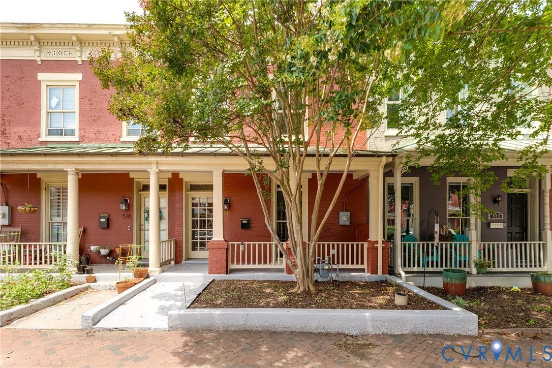 520 N 1st Street, Richmond, VA 23219 Brick exterior with decorative frieze detailing, covered porch with columns, and white railing