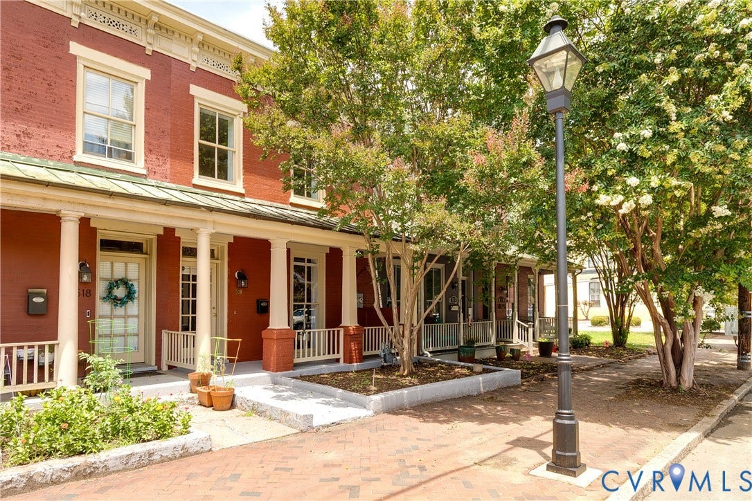 520 N 1st Street, Richmond, VA 23219 Red brick facade with white trim, columned porch, and a covered entry