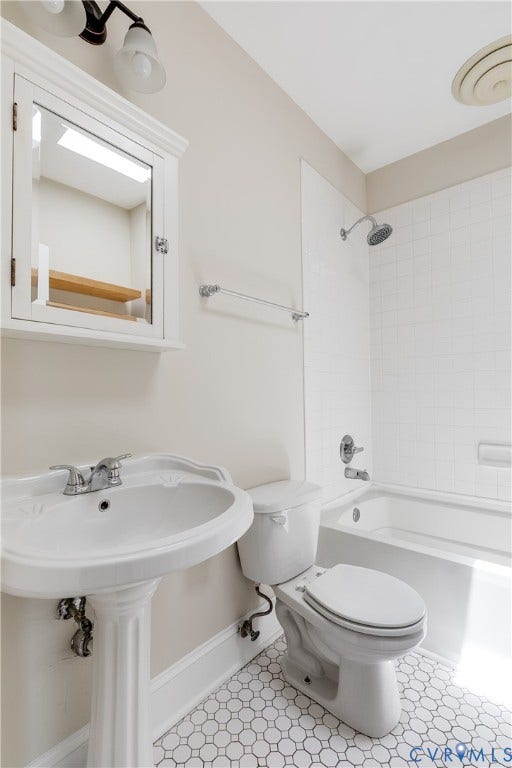 520 N 1st Street, Richmond, VA 23219 White pedestal sink, white subway tile shower surround, white octagonal floor tiles, built-in medicine cabinet, and a white bathtub