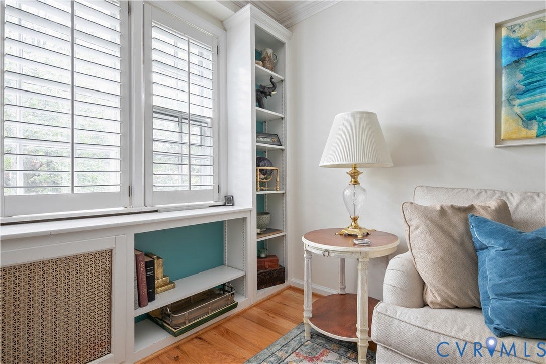 2606 Park Avenue, #U6, The Fan, Richmond, VA 23220 Built-in shelving, custom window shutters, wood-finish flooring, built-in storage, and a patterned radiator cover