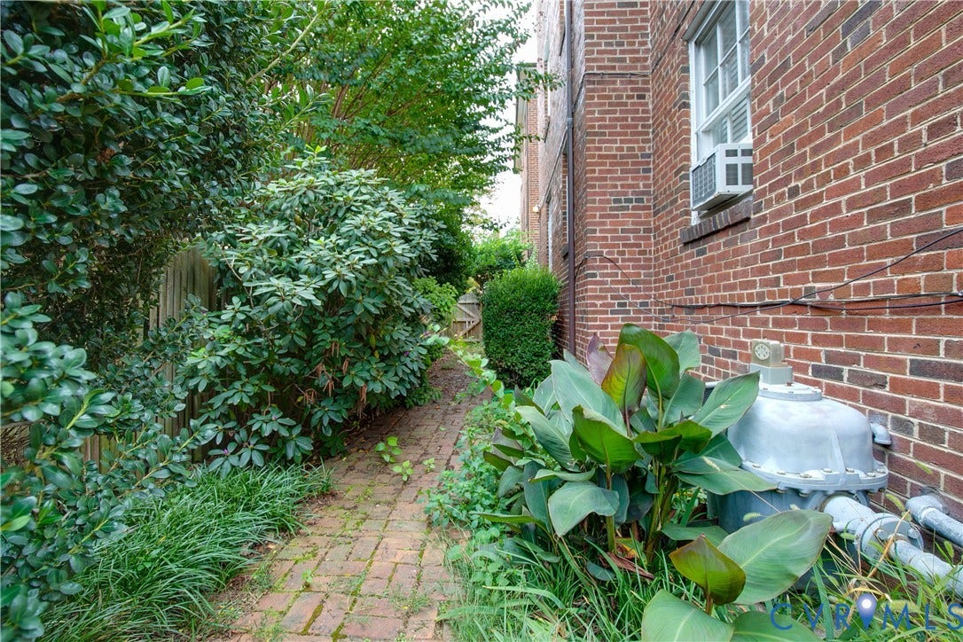 2606 Park Avenue, #U6, The Fan, Richmond, VA 23220 Brick exterior featuring a multi-pane window and a brick-laid pathway