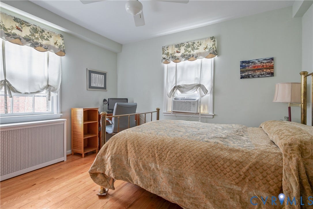 2606 Park Avenue, #U6, The Fan, Richmond, VA 23220 Hardwood flooring, window-mounted air conditioning unit, ceiling fan, and window with exterior building visible