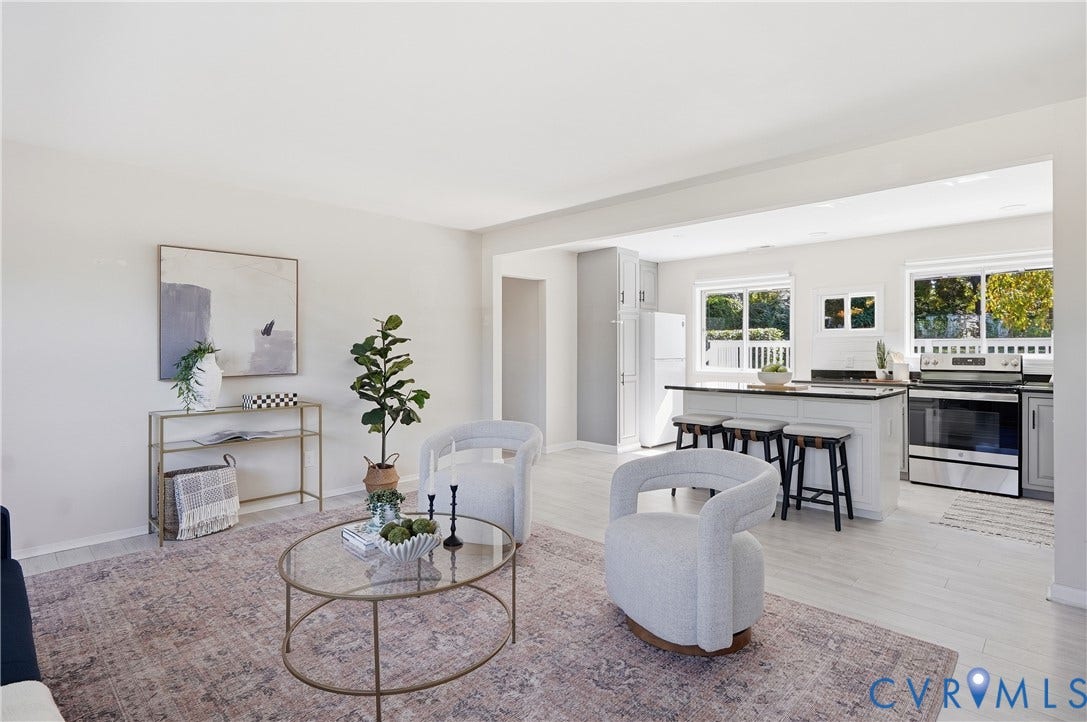 Open-concept living space featuring wood-finish flooring, recessed lighting, and white walls