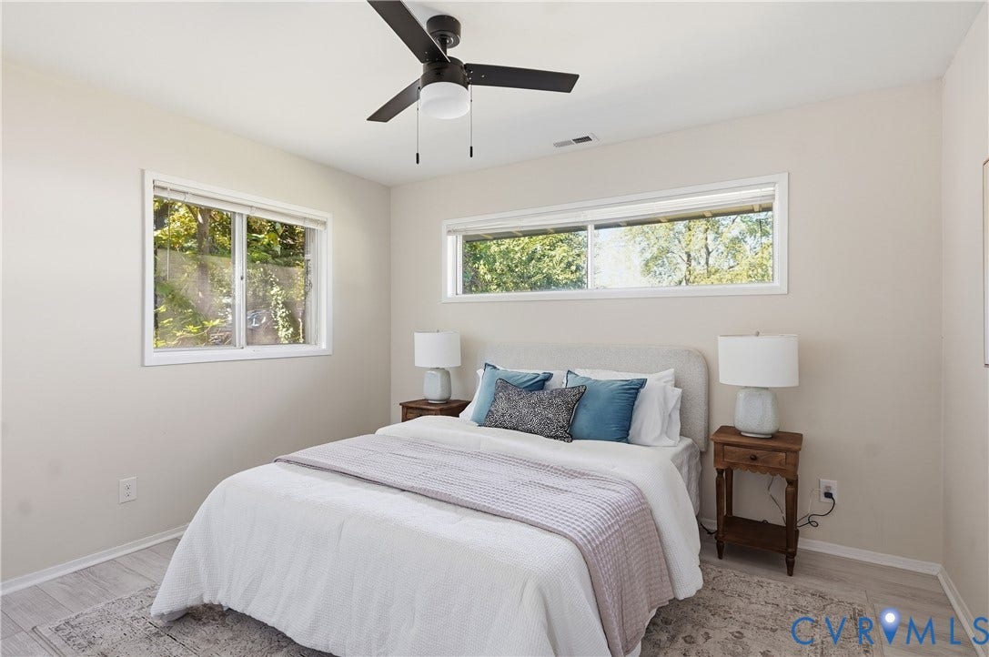 Recessed lighting, wood-finish flooring, two large windows, white walls, and a ceiling fan