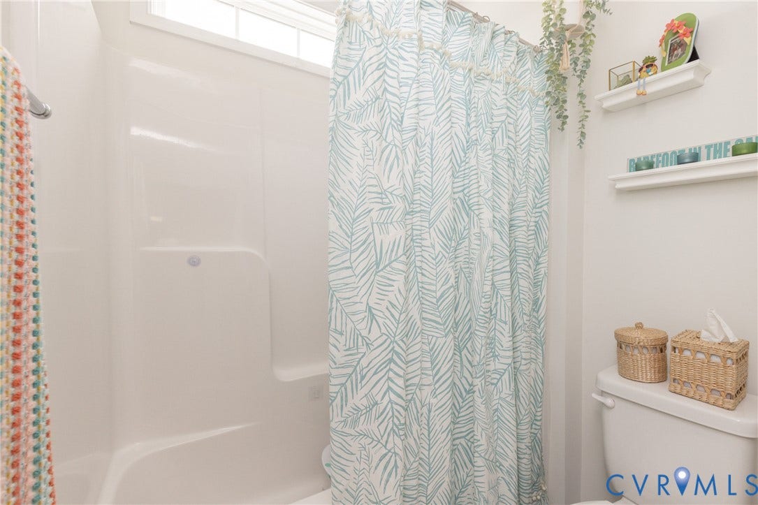 White shower/tub combination with a built-in shelf