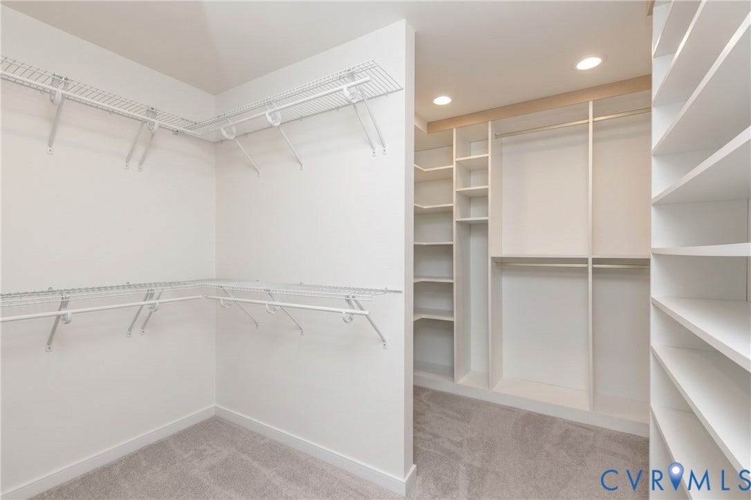 Walk-in closet with carpet flooring, recessed lighting, white wire shelving, and built-in white wood shelving