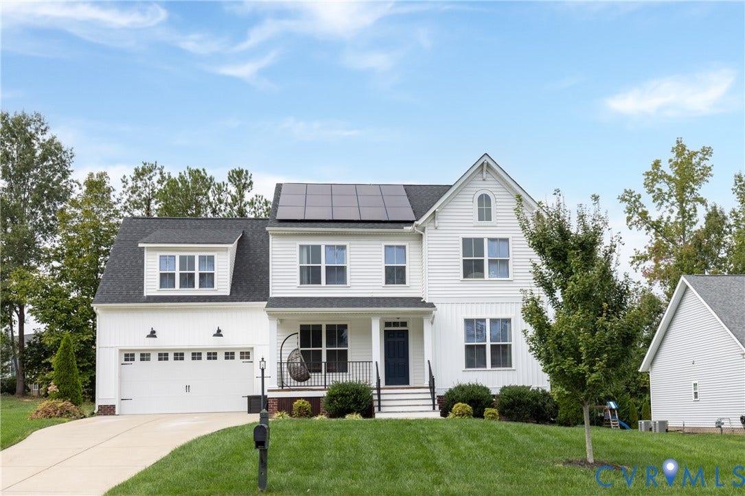 White siding exterior with a dark roofline