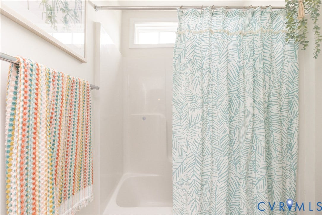 Built-in tub and shower combination with a window for natural light