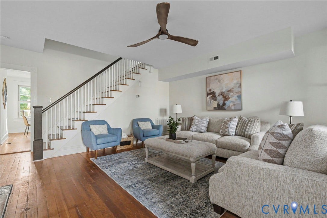 2931 W Leigh Street, Scotts Addition, Richmond, VA 23230 Hardwood flooring, painted white walls, wood-finish ceiling fan, staircase with white risers and dark wood treads