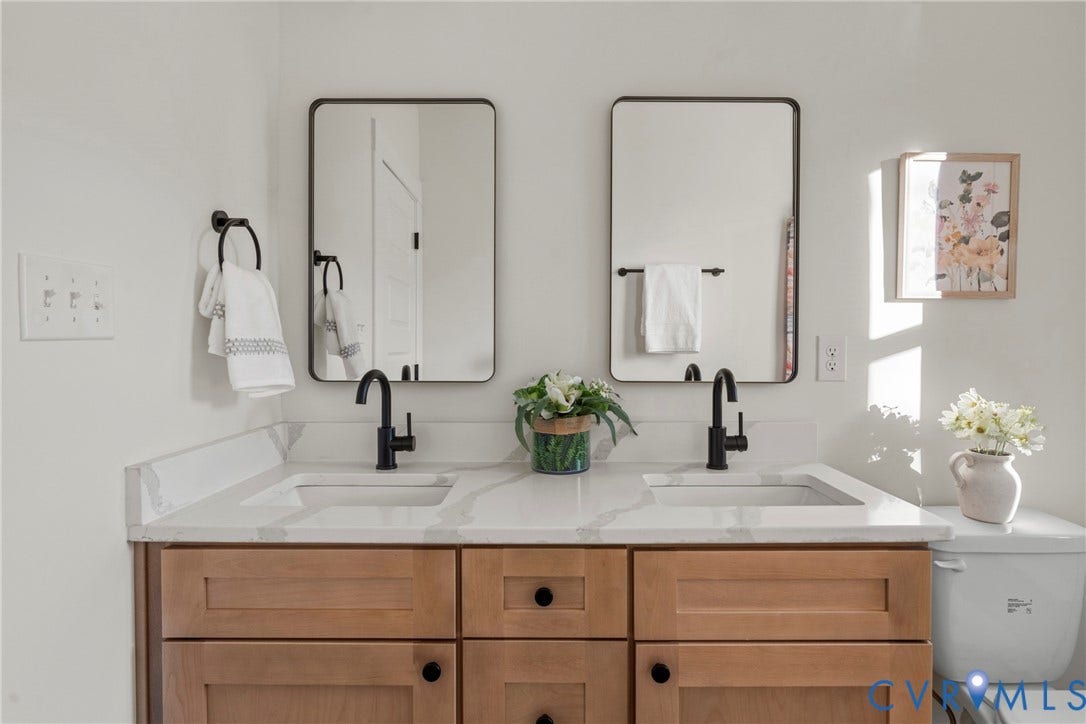 2931 W Leigh Street, Scotts Addition, Richmond, VA 23230 Dual basin vanity with wood-finish cabinetry, white countertops, and matte black fixtures