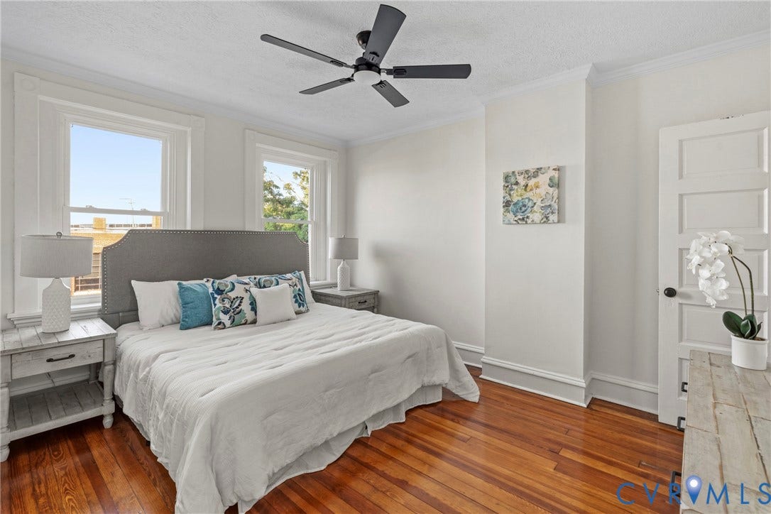 2931 W Leigh Street, Scotts Addition, Richmond, VA 23230 Hardwood flooring, crown molding, a built-in ceiling fan, and a paneled door