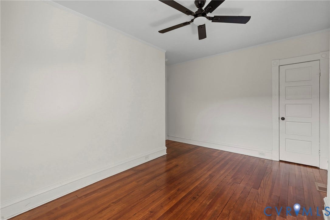2931 W Leigh Street, Scotts Addition, Richmond, VA 23230 Hardwood flooring, ceiling fan, white paneled door, crown molding, and light-toned walls