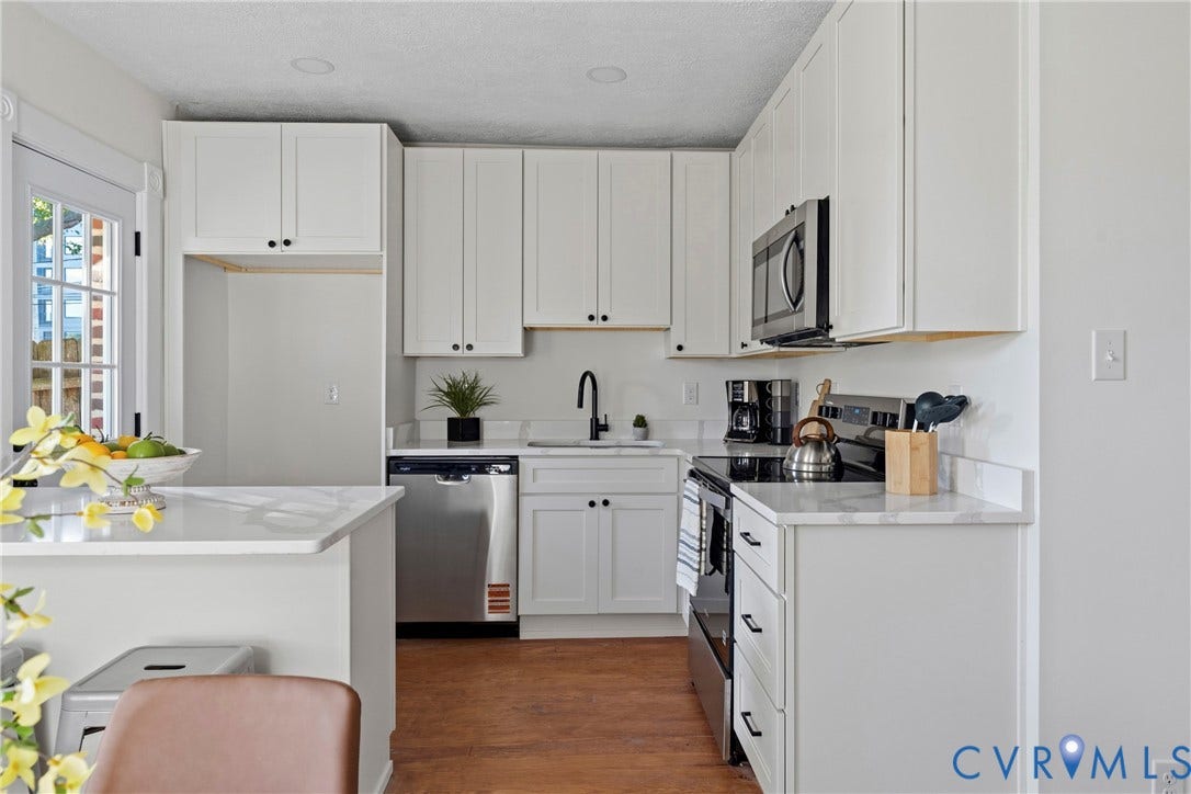 2931 W Leigh Street, Scotts Addition, Richmond, VA 23230 White shaker cabinetry, stainless steel dishwasher, wood-finish flooring, white countertops, and recessed lighting