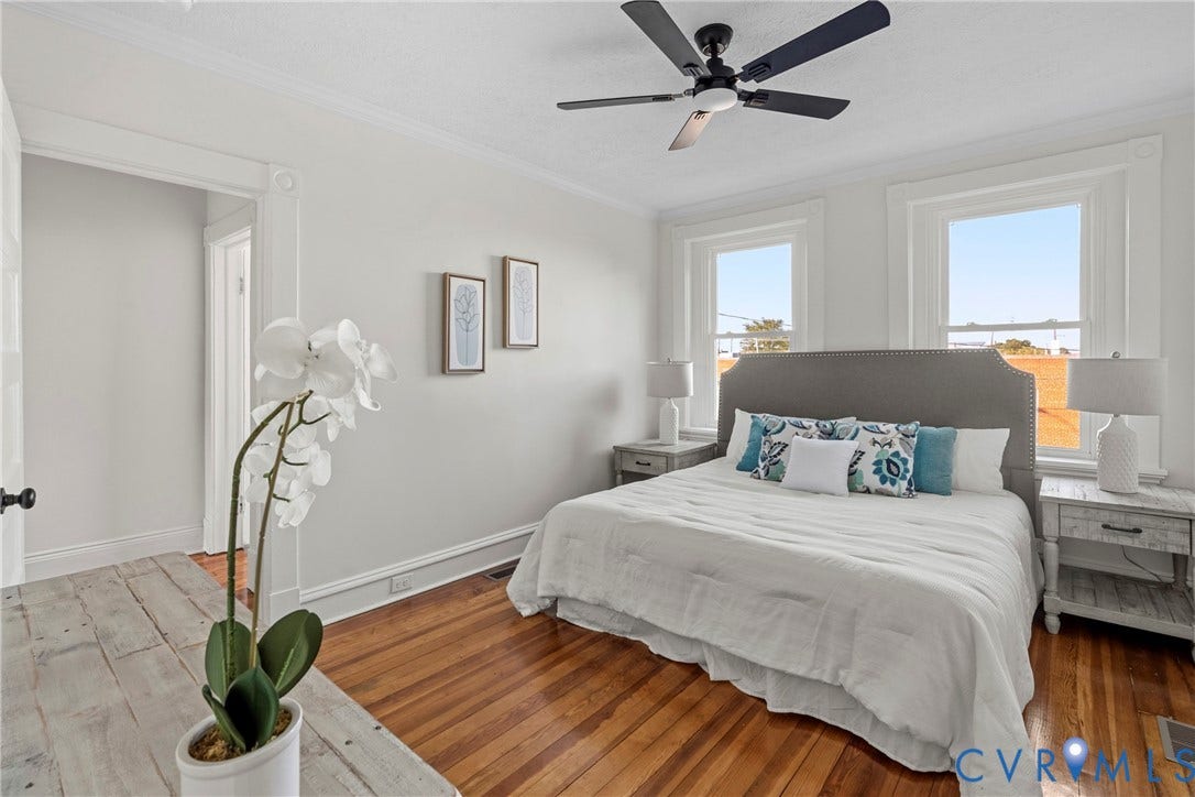 2931 W Leigh Street, Scotts Addition, Richmond, VA 23230 Hardwood flooring, painted trim, crown molding, and two windows with white frames