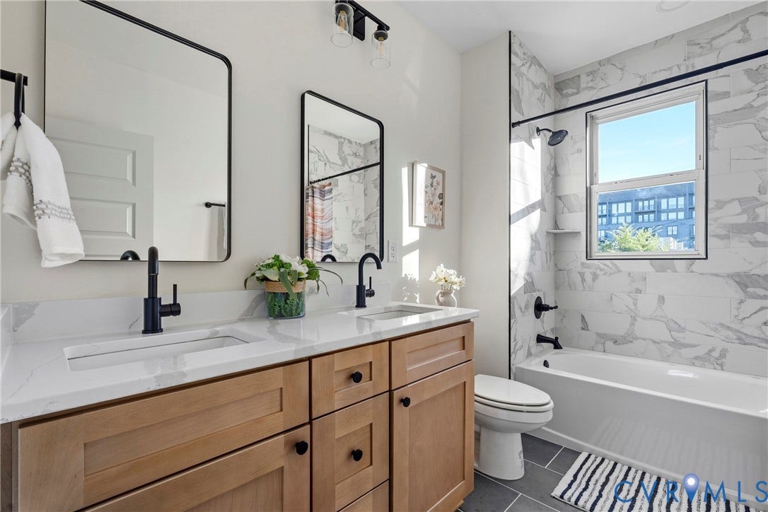 2931 W Leigh Street, Scotts Addition, Richmond, VA 23230 Dual vanity with wood-finish cabinetry, white countertop, and integrated sinks