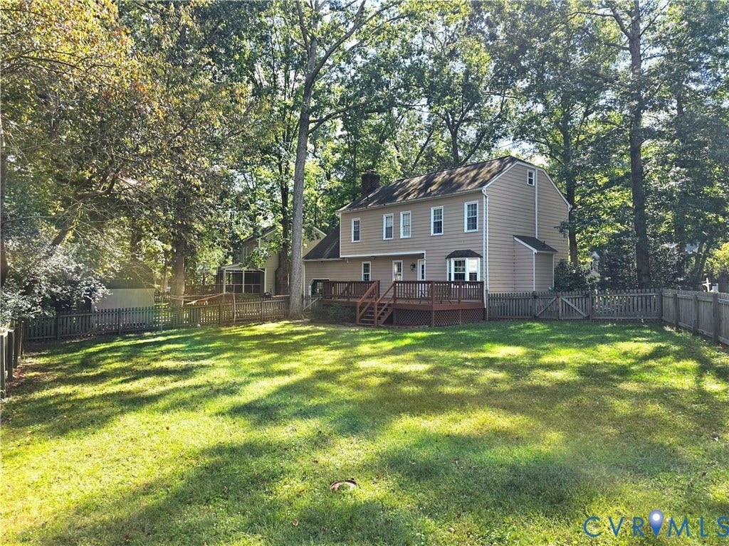 4207 Brixton Road, Creekwood, Chesterfield, VA 23832 Expansive backyard featuring a manicured lawn, wood deck, and a full fence