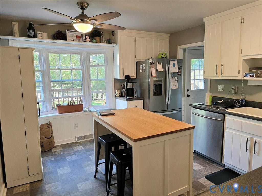 4207 Brixton Road, Creekwood, Chesterfield, VA 23832 White cabinetry, wood-finish island countertop, stainless steel refrigerator, stainless steel dishwasher, and bay windows