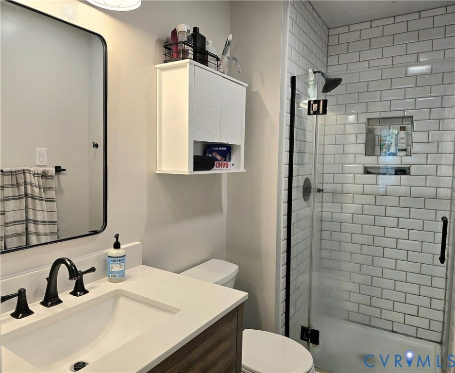 4207 Brixton Road, Creekwood, Chesterfield, VA 23832 Modern bathroom featuring a glass-enclosed shower with subway tile surround, recessed shelving, and a dark bronze showerhead