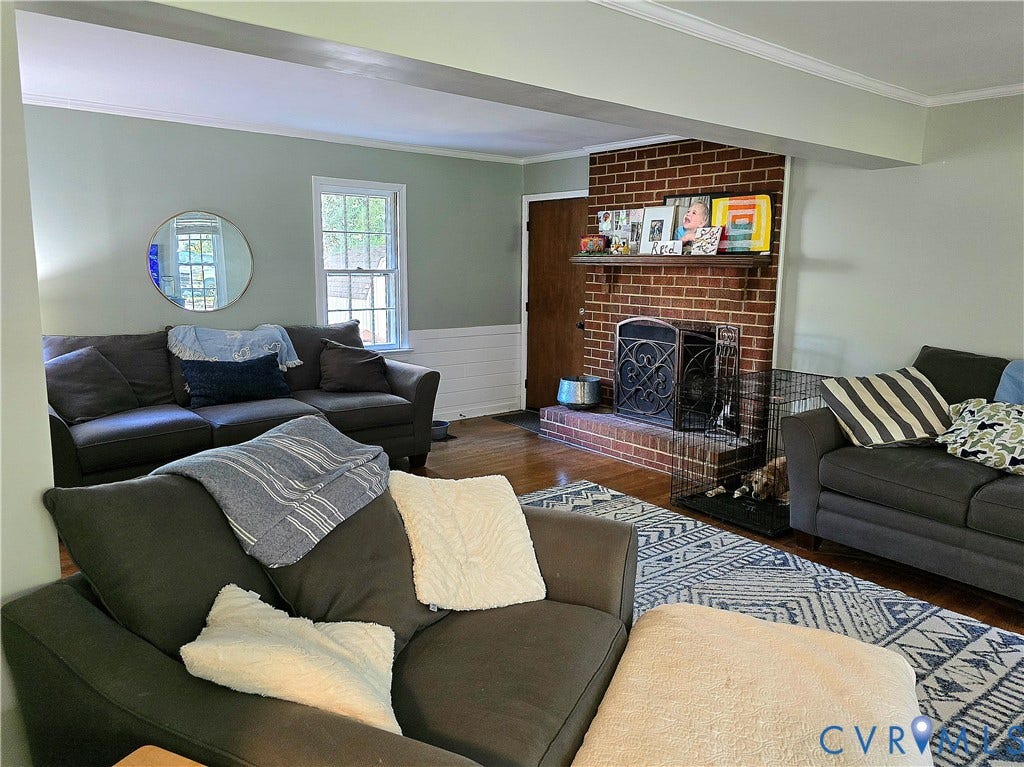 4207 Brixton Road, Creekwood, Chesterfield, VA 23832 Brick fireplace with a wood mantle, wood-finish flooring, white crown molding, and white wainscoting