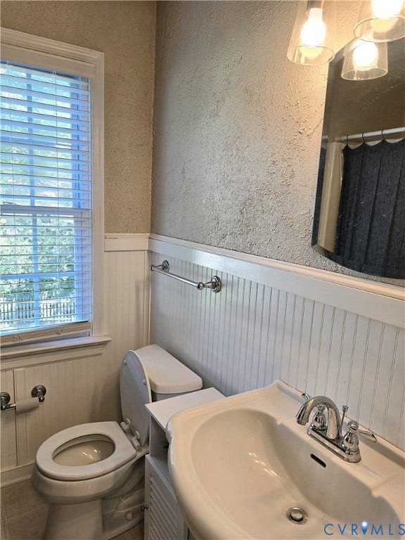 4207 Brixton Road, Creekwood, Chesterfield, VA 23832 Textured wall finish, white beadboard wainscoting, window with blinds, chrome towel bar, and a pedestal sink with chrome faucet