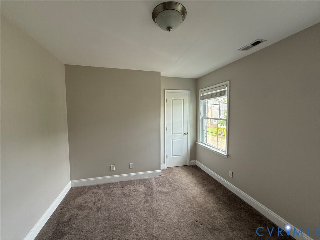 1709 Kemper Street, Richmond, VA 23220 Neutral tone painted walls, light-colored ceiling, flush-mount ceiling light fixture, white trim, and carpet flooring