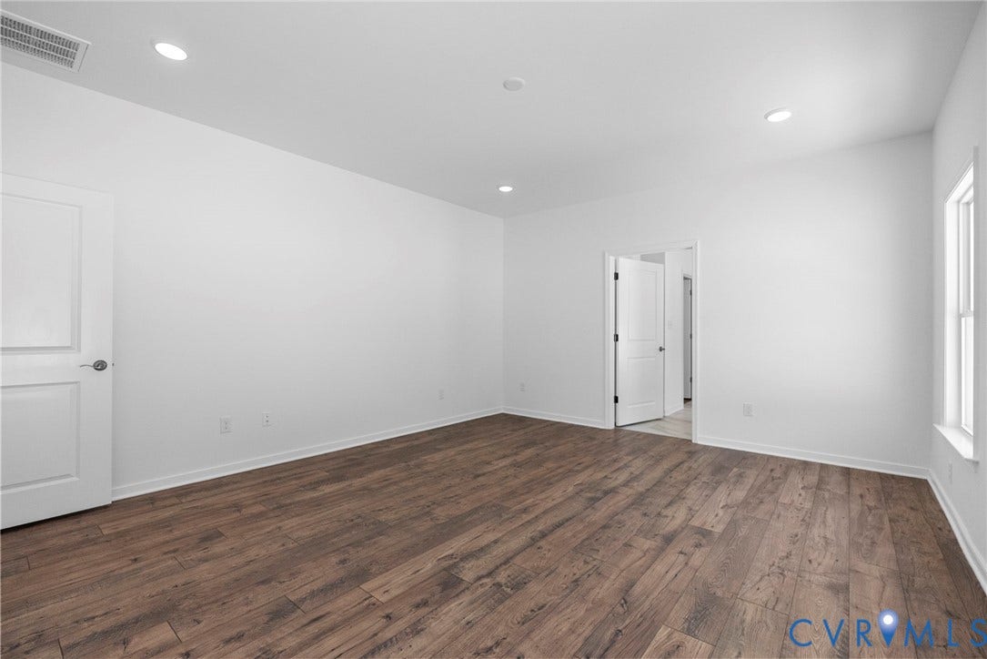 6726 Mayland Ridge Lane, The Villas At Swift Creek, Moseley, VA 23120 Primary bedroom w/ Revwood flooring