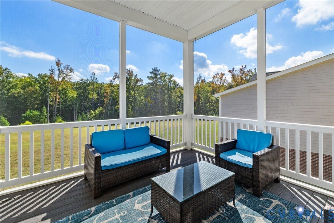 15750 Mosaic Creek Boulevard, Henrico, VA 23238 Screened porch featuring a composite deck, white railings, and a wooded backdrop