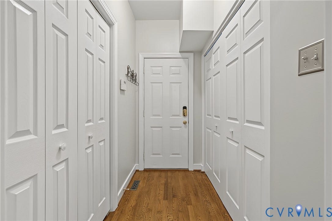 Hallway to garage with storage and washer/dryer