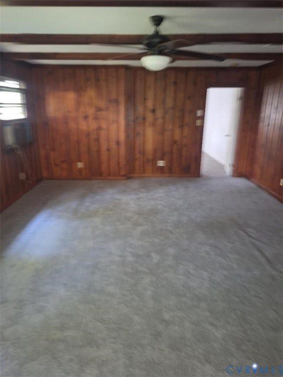 111 Damascus Drive, Richmond, VA 23227 Spacious interior featuring rich wood-paneled walls, neutral carpet flooring, and ceiling fan with integrated lighting