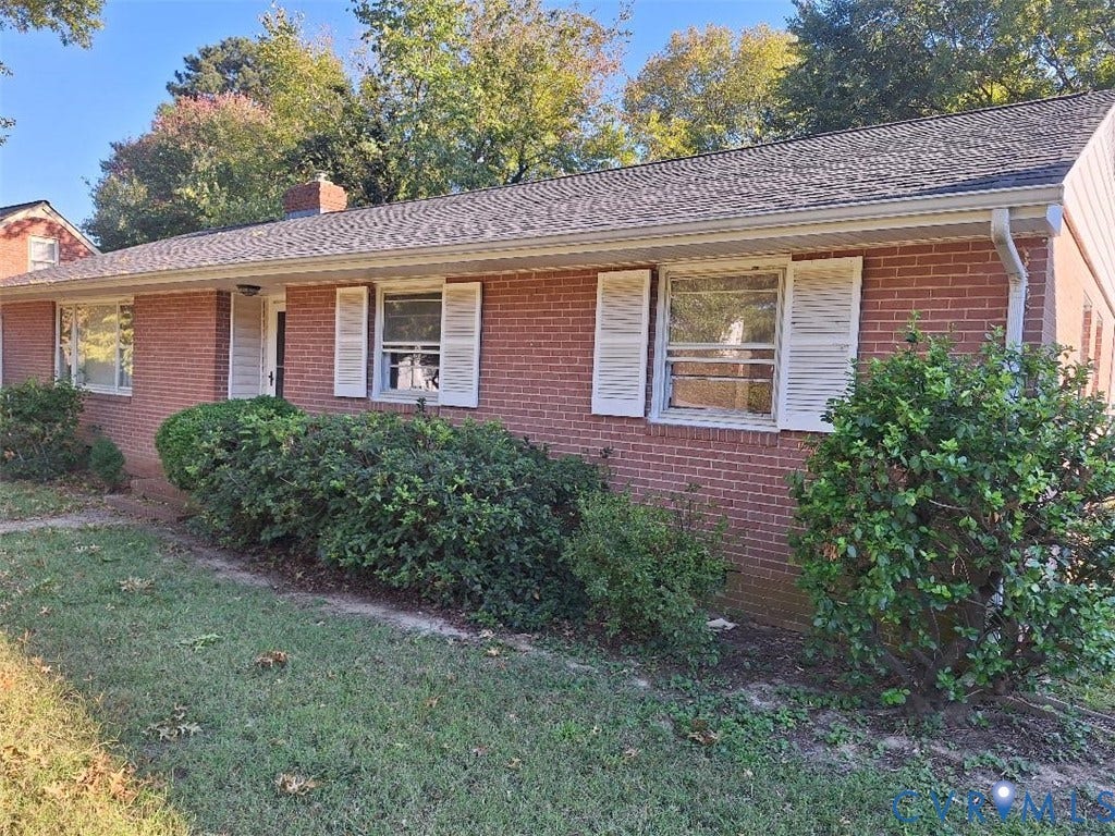 111 Damascus Drive, Richmond, VA 23227 Brick exterior, white window shutters, dark shingle roof, integrated rain gutters, and established front landscaping