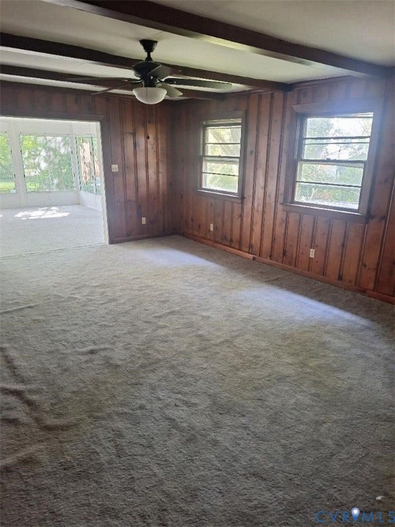 111 Damascus Drive, Richmond, VA 23227 Wood paneling accent wall, exposed ceiling beams, ceiling fan, and multiple windows