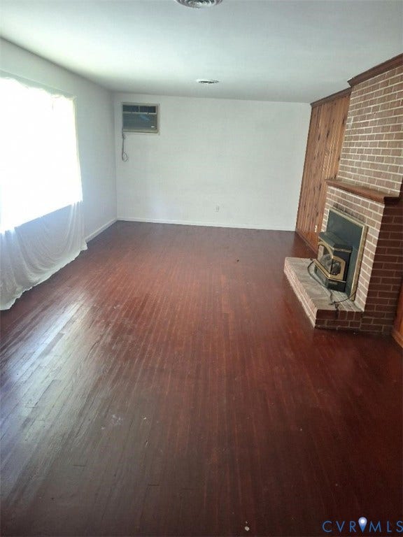 111 Damascus Drive, Richmond, VA 23227 Brick fireplace with a hearth, wood-finish flooring, wood wall paneling, and an air conditioning unit