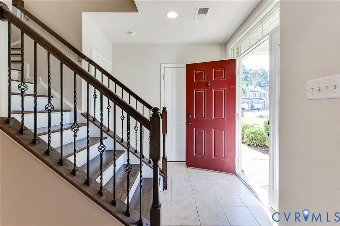 Wood-finish staircase with decorative metal balusters