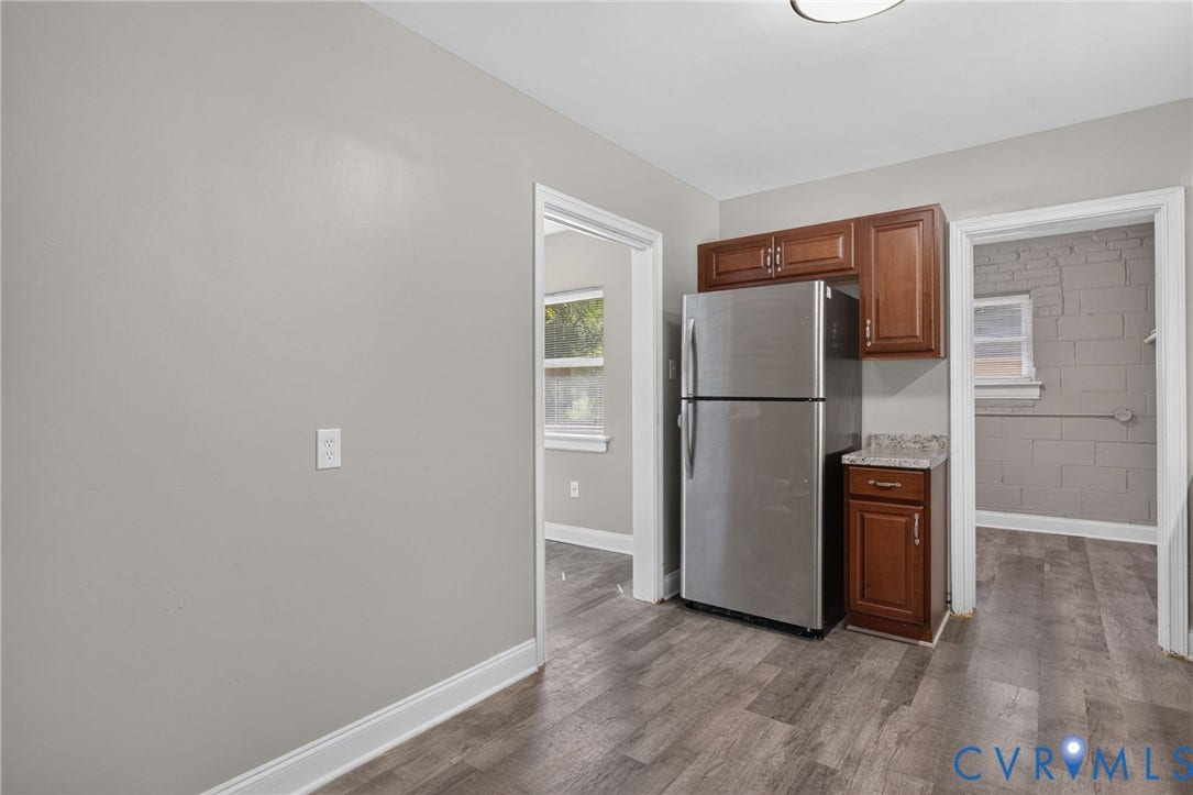 1118 Andros Road, Richmond, VA 23225 light gray walls, stainless steel refrigerator, and wood cabinetry