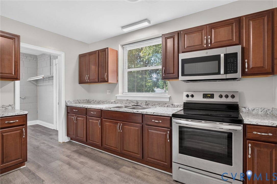 1118 Andros Road, Richmond, VA 23225 Kitchen featuring New LVP flooring, wood cabinetry with brushed nickel hardware, and light-toned countertops