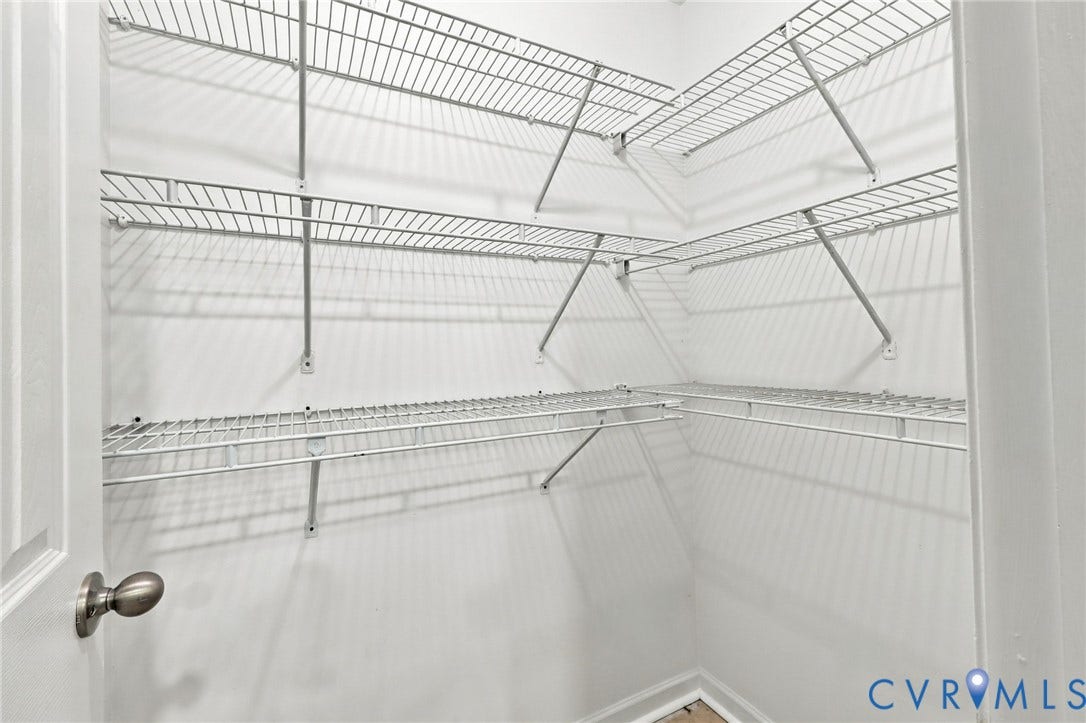 6409 Walmsley Boulevard, Chesterfield, VA 23224 Walk-in storage space featuring tiered white wire shelving and a brushed metal door handle