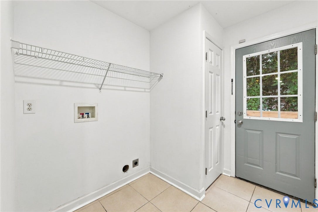 6409 Walmsley Boulevard, Chesterfield, VA 23224 Utility area featuring ceramic tile flooring, a wall-mounted wire shelving unit, dedicated laundry hookups, a six-panel door, and a glass-paneled exterior door
