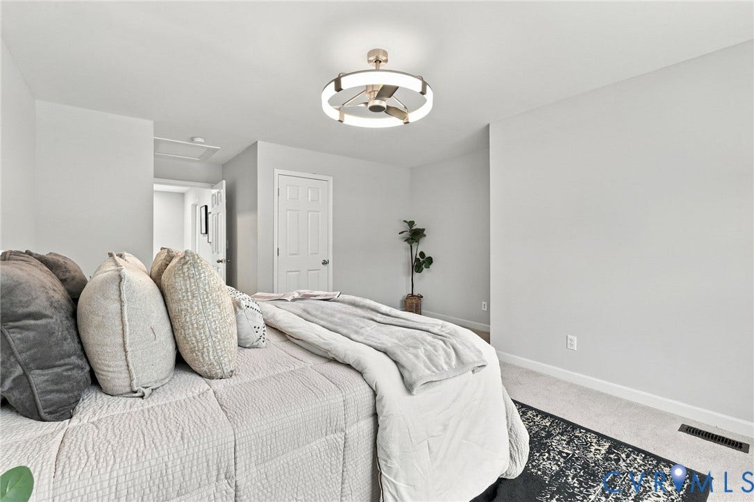 6409 Walmsley Boulevard, Chesterfield, VA 23224 Modern circular flush-mount ceiling fan featuring a metallic finish and integrated ring lighting, complemented by neutral-toned wall-to-wall carpeting and a traditional six-panel interior door