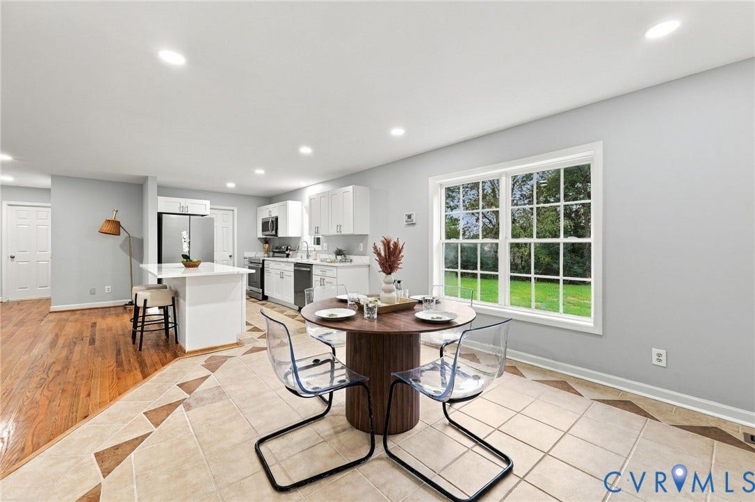 6409 Walmsley Boulevard, Chesterfield, VA 23224 Kitchen featuring white cabinetry, an island with a light-toned countertop, wood-finish flooring, large-format tile flooring with decorative inlay, and recessed lighting