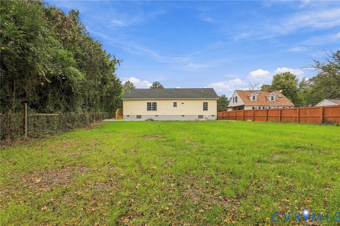 6409 Walmsley Boulevard, Chesterfield, VA 23224 Expansive backyard featuring a level lawn, mature tree line, and full-perimeter wood fencing