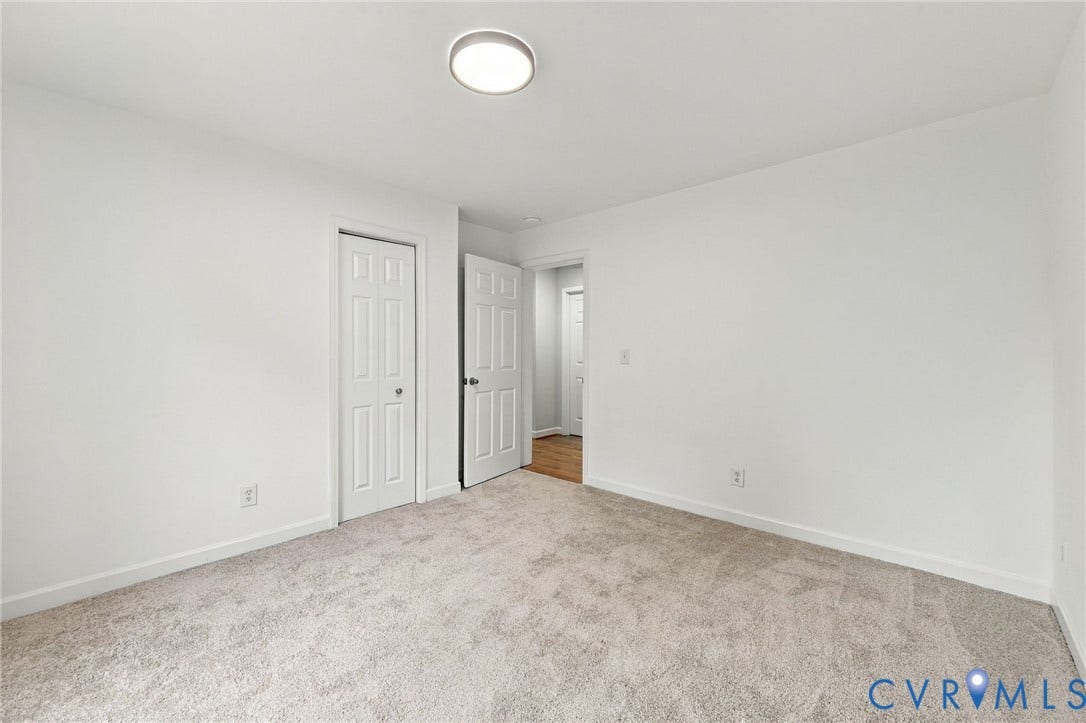 6409 Walmsley Boulevard, Chesterfield, VA 23224 Neutral-toned carpeting, flush-mount LED ceiling lighting, and solid-core six-panel interior doors