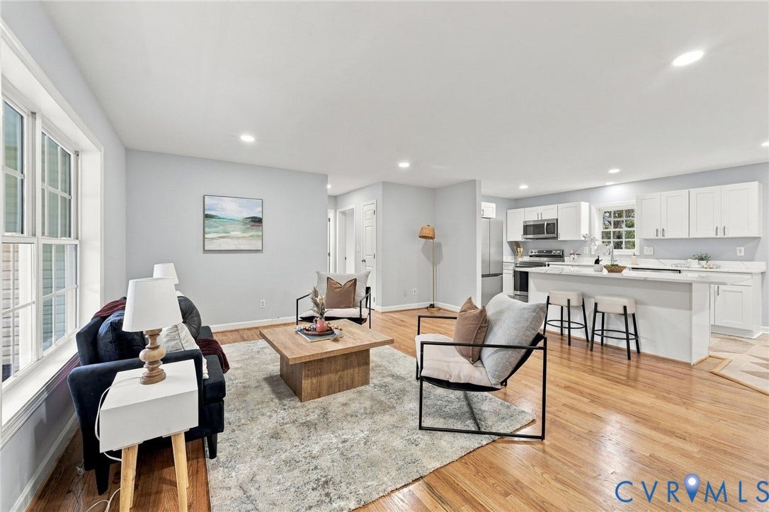 6409 Walmsley Boulevard, Chesterfield, VA 23224 Open-concept area featuring wood-finish flooring, recessed lighting, and a kitchen equipped with white cabinetry, a center island with bar seating, and stainless steel appliances