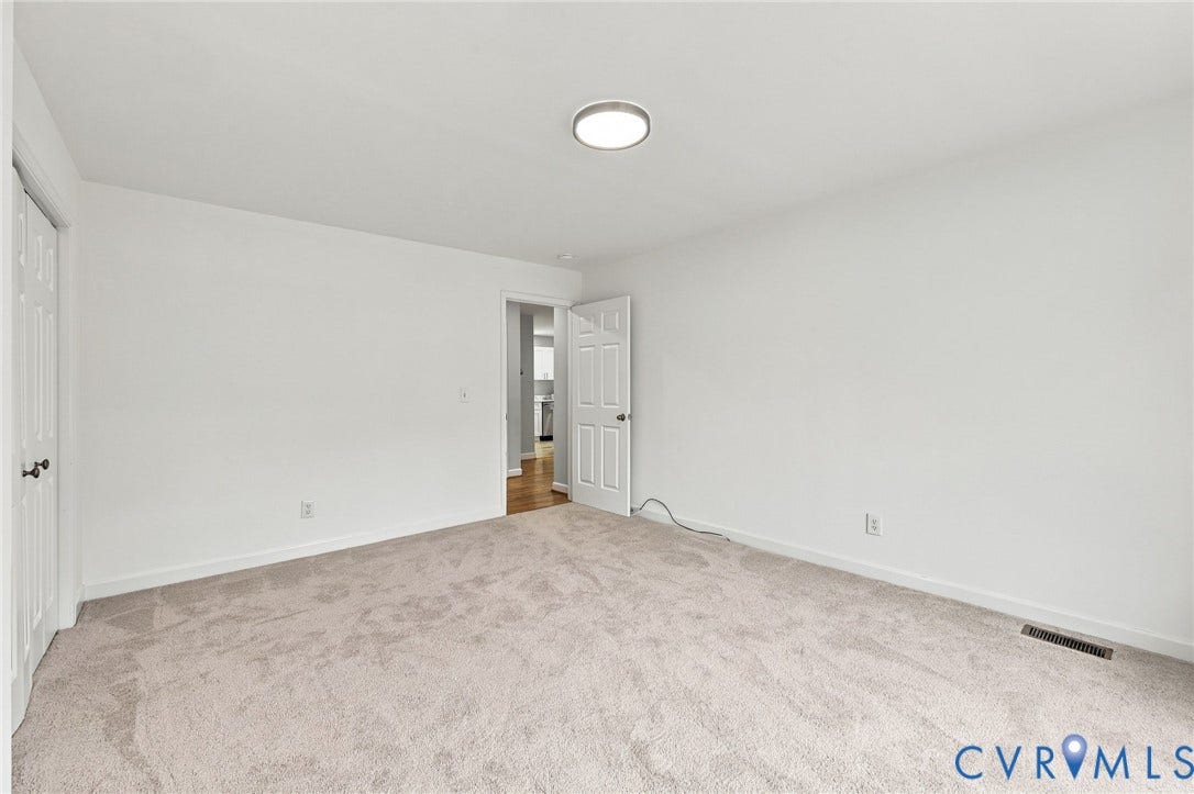 6409 Walmsley Boulevard, Chesterfield, VA 23224 Neutral interior space featuring wall-to-wall carpeting, white walls, six-panel interior doors, and a flush-mount circular ceiling fixture