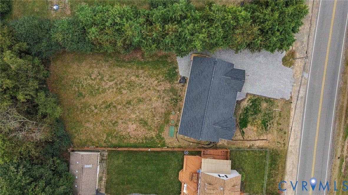 6409 Walmsley Boulevard, Chesterfield, VA 23224 Aerial perspective featuring an expansive parcel of land, gravel driveway, mature perimeter tree lines, and a dedicated storage structure
