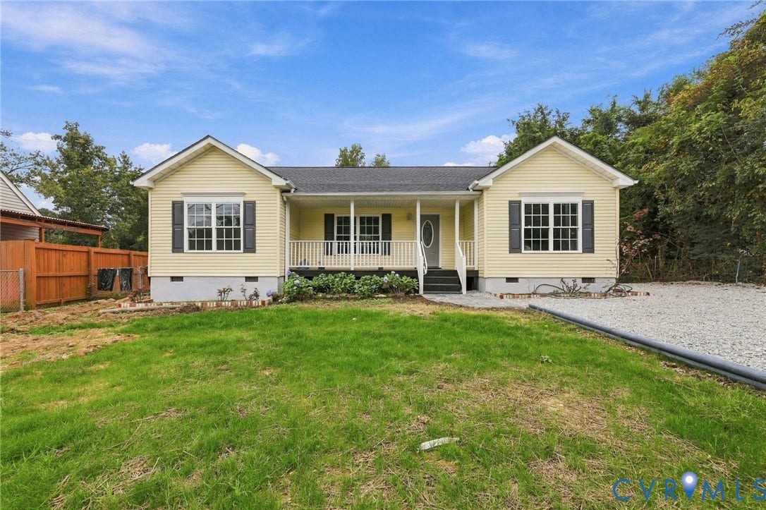 6409 Walmsley Boulevard, Chesterfield, VA 23224 Single-story exterior featuring pale yellow siding, dark grey shutters, a covered front porch with railing, and a gravel driveway